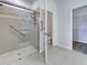 Bright bathroom featuring a walk-in shower, toilet room, and walk-in closet at 9157 Genesee St, Port Charlotte, FL 33981