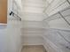 Walk-in closet provides ample storage with multiple wire shelves and efficient organization at 9157 Genesee St, Port Charlotte, FL 33981