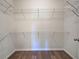 Walk-in closet featuring wood flooring and wire shelving at 9157 Genesee St, Port Charlotte, FL 33981