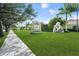 View of the Venice Art Center sign and sculpture, surrounded by lush landscaping and green lawns at 931 Inlet Cir, Venice, FL 34285