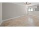 Empty bedroom showcases neutral walls, tiled floors, and a ceiling fan at 931 Inlet Cir, Venice, FL 34285