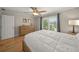 Bright bedroom with wood floors, a ceiling fan and a double-door closet at 931 Inlet Cir, Venice, FL 34285