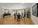 Inviting dining room with hardwood floors and a stylish glass table with seating for six at 931 Inlet Cir, Venice, FL 34285