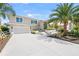 Beautiful two-story home with lush landscaping, a spacious driveway, and an attached two-car garage at 931 Inlet Cir, Venice, FL 34285