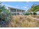 Charming waterfront home featuring a private dock, lush landscaping, and inviting exterior, perfect for coastal living at 931 Inlet Cir, Venice, FL 34285