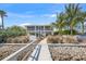Charming waterfront home featuring a private dock, lush landscaping, and inviting exterior, perfect for coastal living at 931 Inlet Cir, Venice, FL 34285