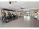 Spacious garage with epoxy floors, golf cart, surfboards and views of the water at 931 Inlet Cir, Venice, FL 34285