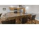 Charming kitchen featuring an island, granite countertops, and stainless steel appliances at 931 Inlet Cir, Venice, FL 34285