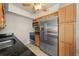 Kitchen includes stainless steel appliances, granite counters and wood cabinetry at 931 Inlet Cir, Venice, FL 34285