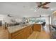 Bright, modern kitchen with stainless appliances, granite countertops, and barstool seating at 931 Inlet Cir, Venice, FL 34285