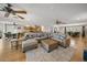 Spacious living room with hardwood floors, comfortable seating, and an open layout at 931 Inlet Cir, Venice, FL 34285