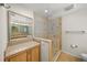 Bright and airy main bathroom with large shower, tile floors, and granite vanity top at 931 Inlet Cir, Venice, FL 34285
