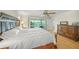 Spacious main bedroom offers water views, wood floors, a ceiling fan and an en suite bathroom at 931 Inlet Cir, Venice, FL 34285
