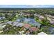 Real estate aerial view featuring a lake surrounded by homes and golf course at 9528 Knightsbridge Cir, Sarasota, FL 34238