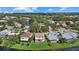 Scenic aerial view of homes with lush landscaping and lakeside views at 9528 Knightsbridge Cir, Sarasota, FL 34238