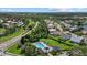 Aerial view of a community pool, clubhouse, and surrounding landscape at 9528 Knightsbridge Cir, Sarasota, FL 34238
