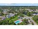 Aerial view of community pool and clubhouse with lush greenery in a neighborhood at 9528 Knightsbridge Cir, Sarasota, FL 34238
