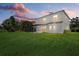 Exterior view of the home featuring a screened-in porch and a spacious yard, perfect for outdoor activities at 9528 Knightsbridge Cir, Sarasota, FL 34238
