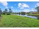 Picturesque backyard with a peaceful pond view and well-maintained landscaping for relaxation and enjoyment at 9528 Knightsbridge Cir, Sarasota, FL 34238
