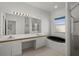Bathroom featuring double sinks, large mirrors, and a walk-in shower and a tub at 9528 Knightsbridge Cir, Sarasota, FL 34238