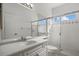 Bathroom with tiled floor, glass shower doors, and a white vanity at 9528 Knightsbridge Cir, Sarasota, FL 34238