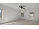 Spacious bedroom with neutral carpet, multiple windows, and a ceiling fan at 9528 Knightsbridge Cir, Sarasota, FL 34238