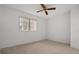 Carpeted bedroom with ceiling fan and a window letting in natural light at 9528 Knightsbridge Cir, Sarasota, FL 34238