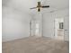 Spacious carpeted bedroom with access to a bathroom and stairway at 9528 Knightsbridge Cir, Sarasota, FL 34238