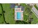 Aerial view of a large community pool surrounded by lush landscaping and lounge chairs at 9528 Knightsbridge Cir, Sarasota, FL 34238