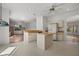 Open kitchen featuring an island with sink, white cabinets and a refrigerator at 9528 Knightsbridge Cir, Sarasota, FL 34238
