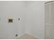 Small laundry area with access for machines and a utility closet at 9528 Knightsbridge Cir, Sarasota, FL 34238