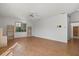 Bright living room with a ceiling fan, wood floors, and large windows at 9528 Knightsbridge Cir, Sarasota, FL 34238
