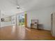 Spacious living room featuring sliding glass doors, ceiling fan, and wood floors at 9528 Knightsbridge Cir, Sarasota, FL 34238