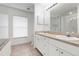 Bathroom featuring a double sink vanity, tiled flooring, and a shower/tub with blinds at 2397 Morton Rd, North Port, FL 34291