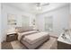Staged bedroom with neutral decor, carpet flooring, and natural light from two windows at 2397 Morton Rd, North Port, FL 34291
