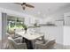 Dining area features modern table set and access to patio and open kitchen at 2397 Morton Rd, North Port, FL 34291