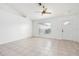 Bright, empty room featuring tile floors, neutral paint, and a ceiling fan at 2397 Morton Rd, North Port, FL 34291