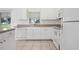 Bright kitchen featuring white cabinets, counter, and stainless steel sink at 2397 Morton Rd, North Port, FL 34291