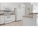 Well-maintained kitchen features white appliances, tile flooring, and ample counter space at 2397 Morton Rd, North Port, FL 34291