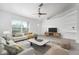 Relax in this bright living room featuring neutral decor and large windows that offer a serene view at 2397 Morton Rd, North Port, FL 34291