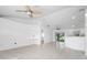 Open-concept living room featuring tile floors, ceiling fan, and access to outdoor area at 2397 Morton Rd, North Port, FL 34291