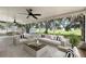 Inviting screened patio with comfortable seating, ceiling fans, and expansive views of the lush backyard at 2397 Morton Rd, North Port, FL 34291