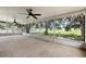 Screened patio featuring tile floors, ceiling fans, and picturesque views of the surrounding greenery at 2397 Morton Rd, North Port, FL 34291