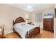 Cozy bedroom with traditional furnishings, decorative curtains, and tiled floor at 102 Bayamo Dr, North Port, FL 34287