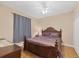 Comfortable bedroom features dark wood furnishings, carpeted floors, and a ceiling fan at 102 Bayamo Dr, North Port, FL 34287