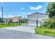Well-maintained property with a secure fence, a large detached garage, and a lush lawn at 102 Bayamo Dr, North Port, FL 34287