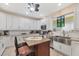 Bright kitchen with stainless appliances, white cabinets, granite counters, and a beautiful farmhouse sink at 102 Bayamo Dr, North Port, FL 34287