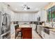 Bright kitchen with white cabinets, stainless steel appliances, and a center island at 102 Bayamo Dr, North Port, FL 34287