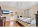 Bedroom featuring a ceiling fan, TV, tile flooring, and ensuite bathroom at 102 Bayamo Dr, North Port, FL 34287