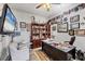 Functional home office with built-in bookshelves, a large desk, and plenty of natural light at 102 Bayamo Dr, North Port, FL 34287